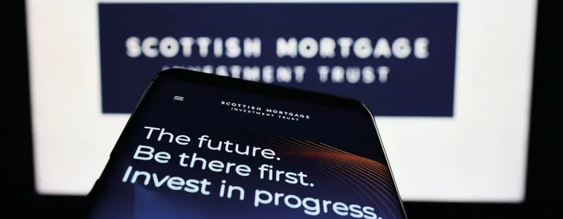 A phone that has the wording 'The future. Be there first. Invest in progress.' on the screen.