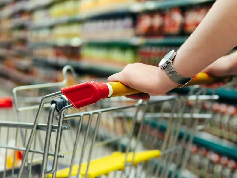 Shopper pushing shopping trolley