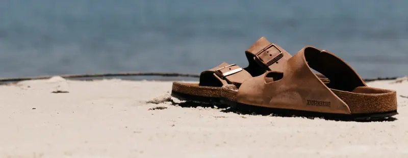 pair of sandals on a sandy beach