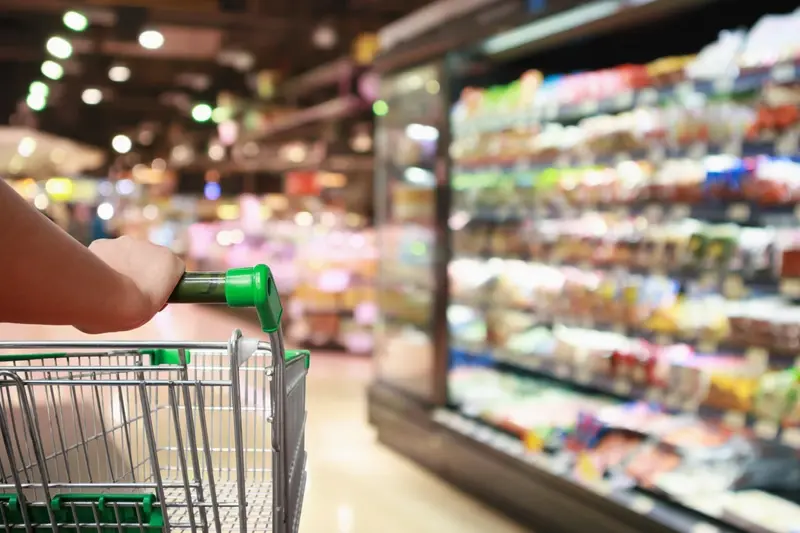 Shopper entering supermarket blurred