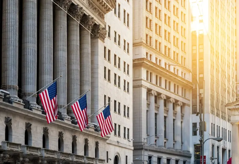 US flags flying on Wall Street