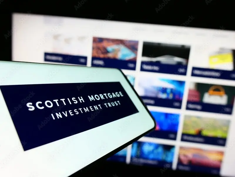  Mobile phone with logo of Scottish Mortgage Investment Trust plc on screen in front of company website. 