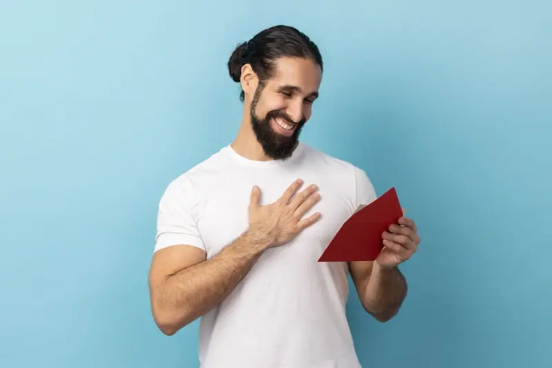Man looking happy about receiving a greetings card