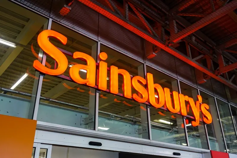Sainsbury's logo above the entrance to a supermarket store