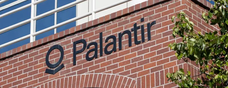 Palantir logo on a brick wall