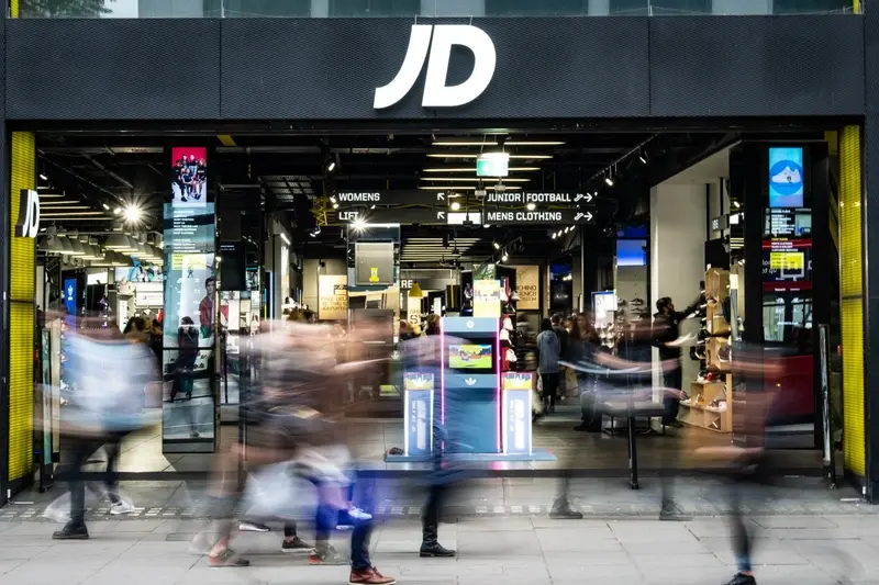 Blurred image of shoppers outside JD Sports