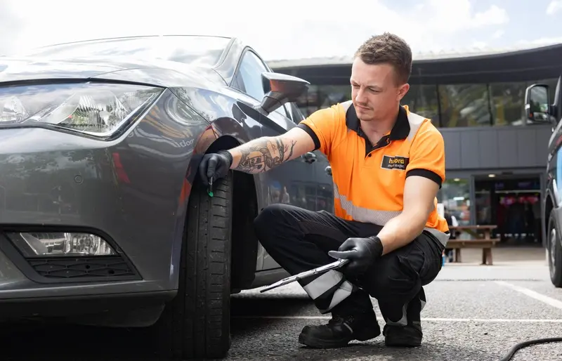 A Halfords worker checking tyres