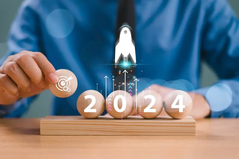 Man counting against 2024 sign with rocket going up