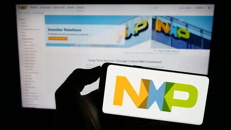 NXP mobile app against company investors relations page on laptop 