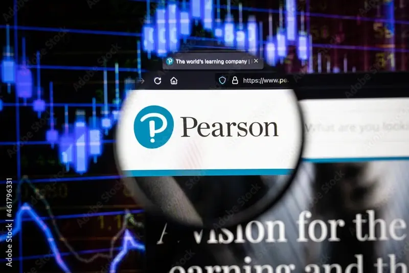 Pearson company logo on a website with blurry stock market graphs in the background, seen on a computer screen through a magnifying glass.