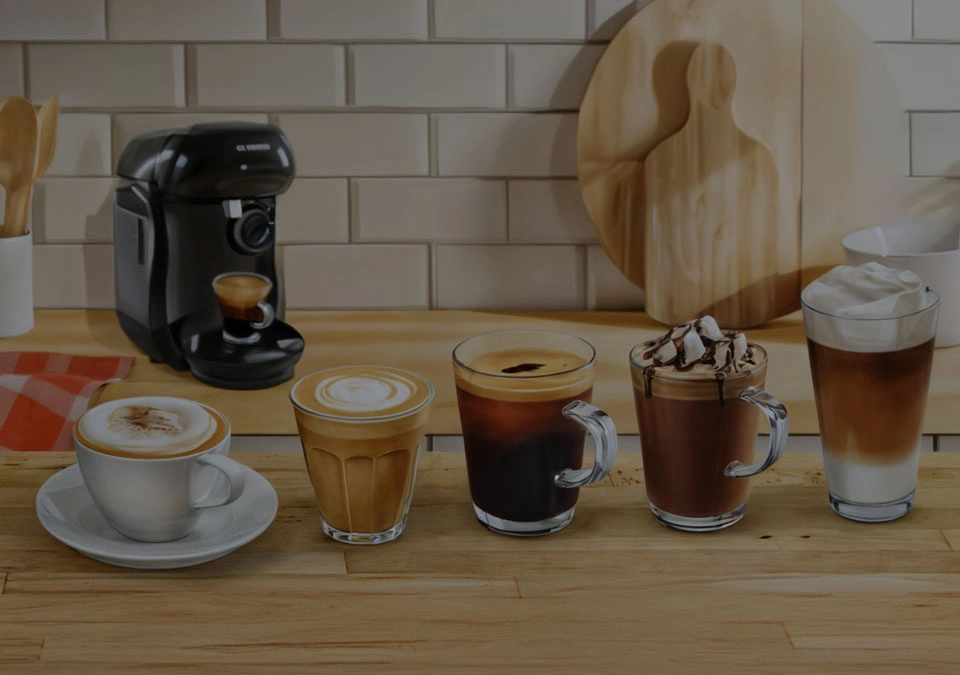 TASSIMO brewed coffee options, including espresso, cappuccino, latte, americano, and classic brew, on a rustic wooden counter.