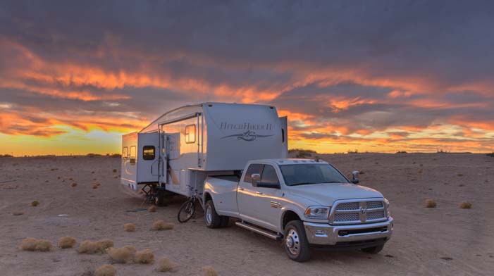 A fifth wheel RV at sunset