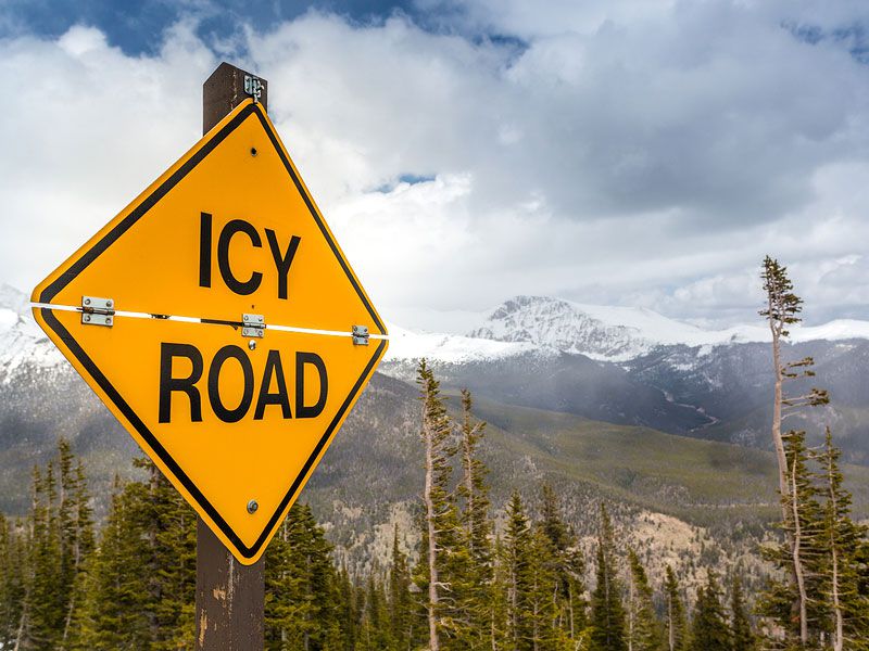 Icy Road Sign ・  Photo by Bigstock 