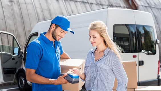 Woman receiving medical equipment packages from delivery driver