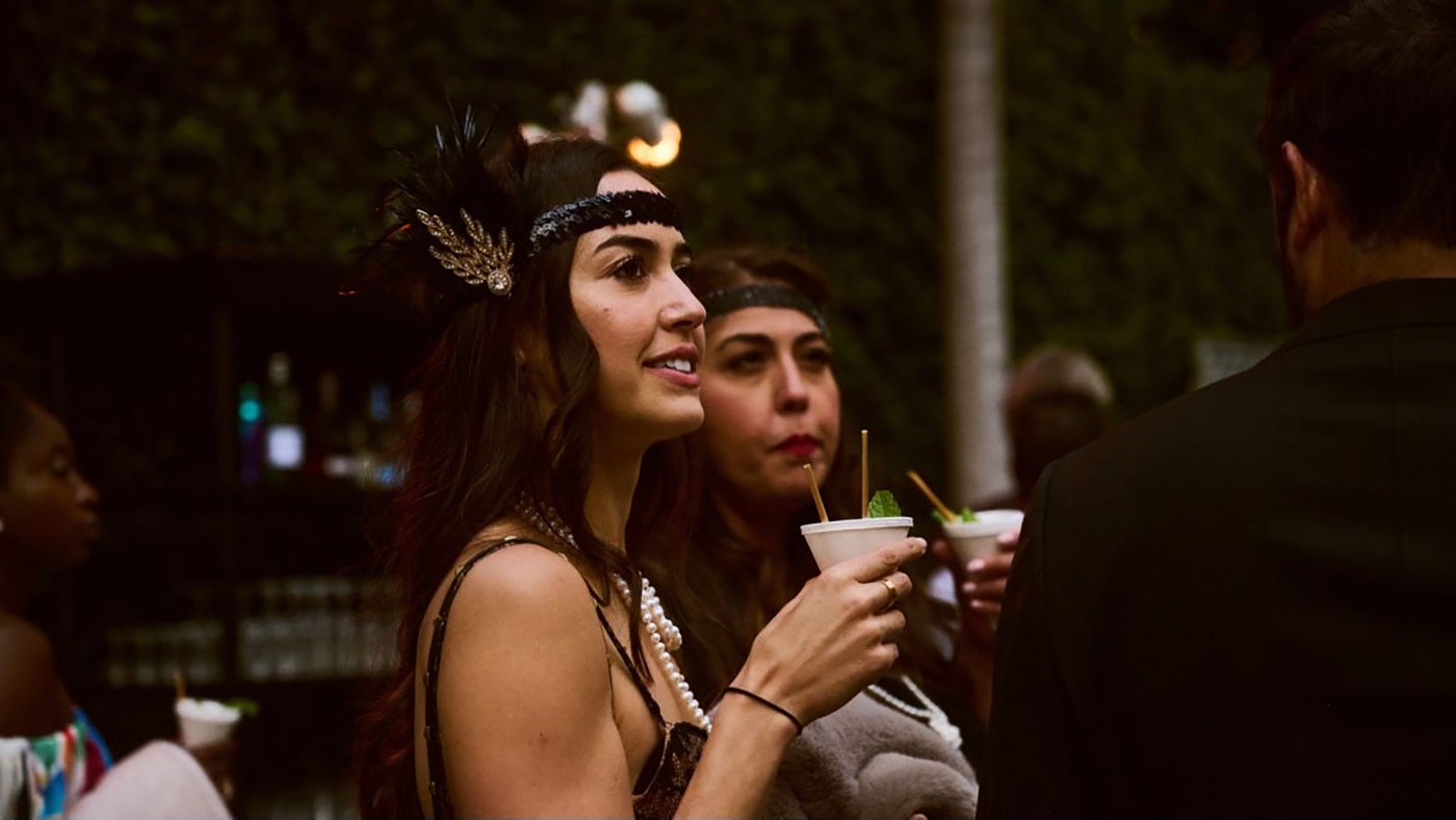 woman holding a cocktail in a cone