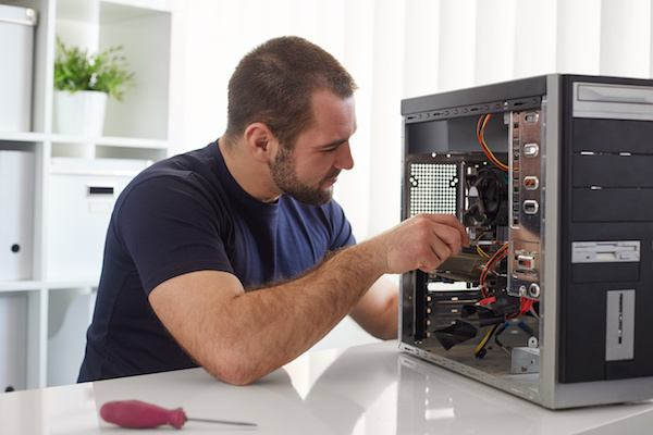 Technician working on a computer leasing tower