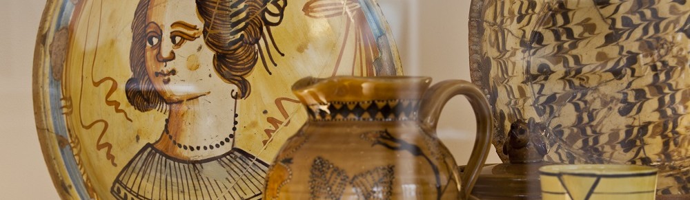 Photograph showing details of slipware plates and a jug from the Centre for Ceramic Art. (© CoCA/York Museums Trust)