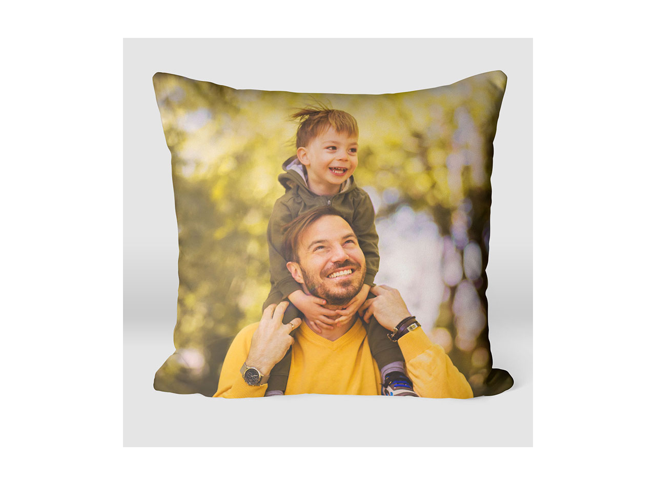 A pillow featuring an image of a father and young son smiling 