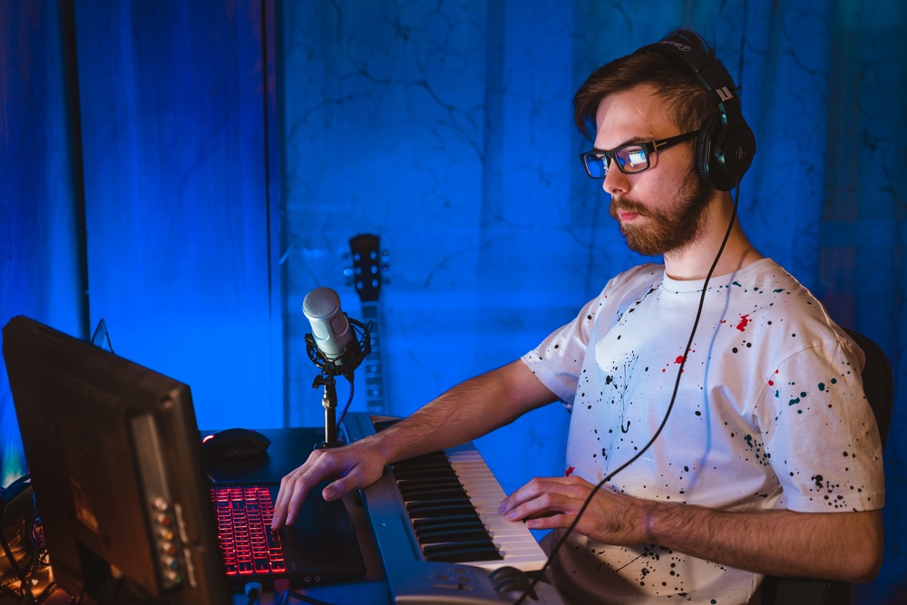 Musician wearing an headset creating music online