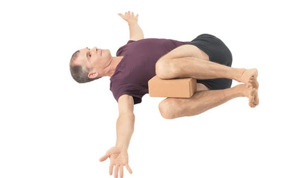 Add a yoga block in between your knees