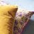 yellow and purple decorative throw pillows 