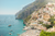 a village cliff facing the beach in positano