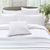 white duvet set on a bed with a grey headboard 