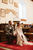 newlyweds sitting at their ceremony in a church hall