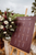mauve wedding sign on easel next to flower bouquet 