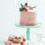Blush naked water colour cake on stand with pink doughnuts 