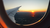 aeroplane window at sunset over a city landscape