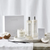 the white company bathroom gift set next to a lit candle 