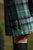 a closeup picture of a groom wearing a kilt