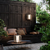 outdoor dark brown wooden seating area with greenery 
