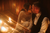 newlyweds kissing in a candlelit room