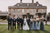 Bride and groom with bridesmaids outside Cotswolds wedding venue