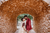 bride and groom kissing under a stone cave