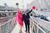 Newlyweds celerbating by the sea with a pink poncho