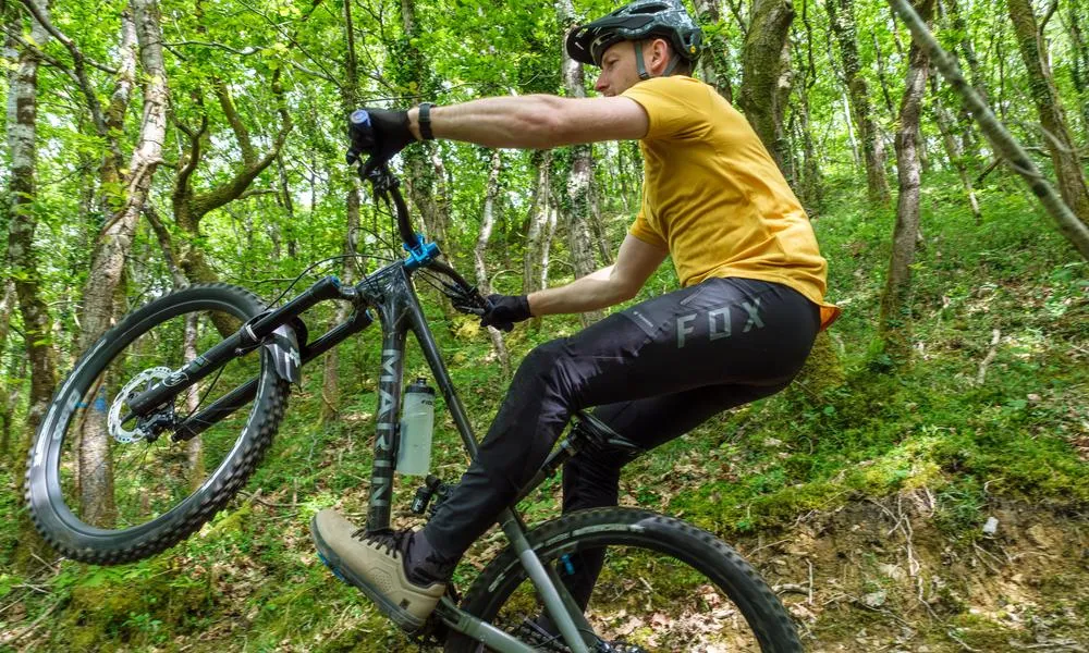 riding a mountain bike in the woods on a spring day