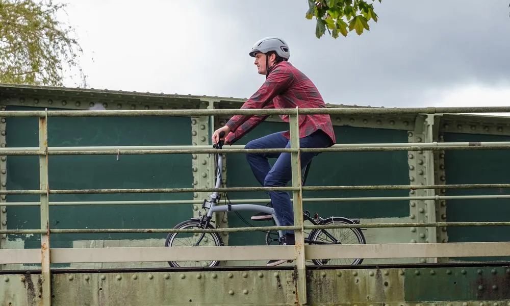 Commuting on a Brompton in a red shirt