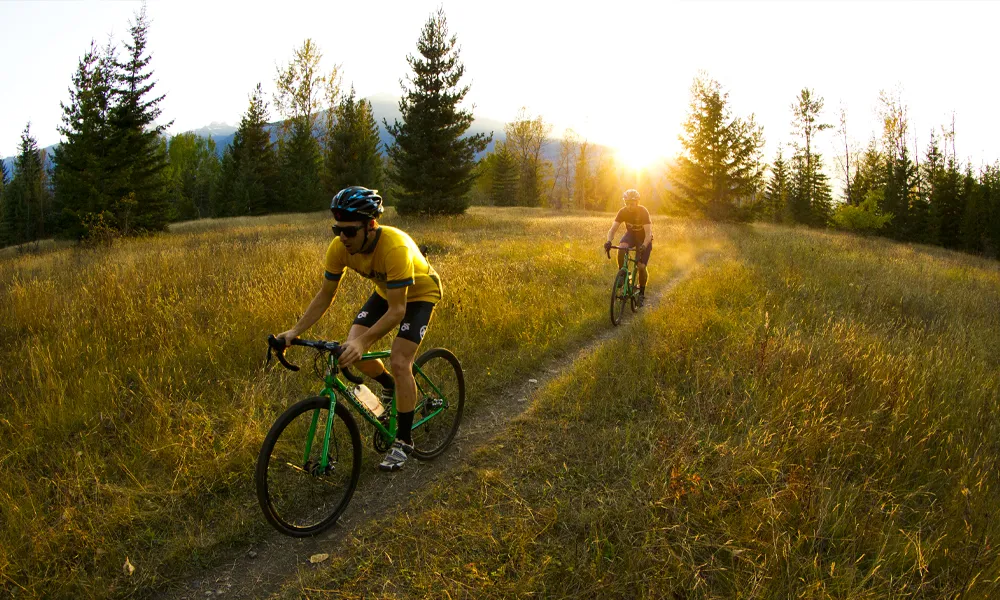 Gravel bikes with Maxxis tyres are ridden at sunset