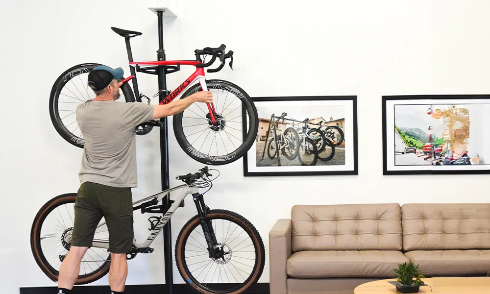 man putting a bike on a bike rack