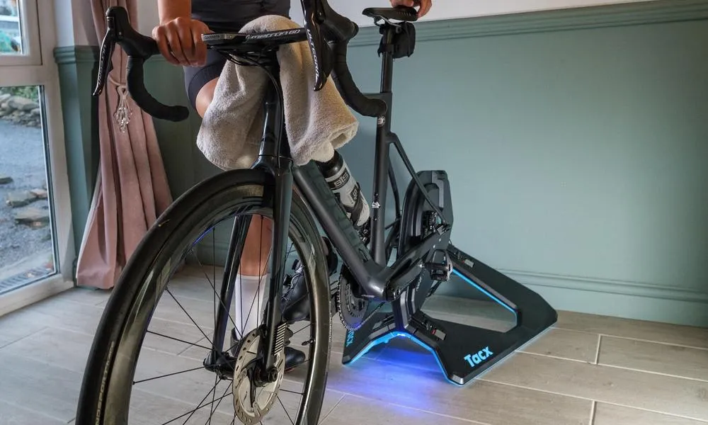 a merida road bike set up on a smart turbo trainer