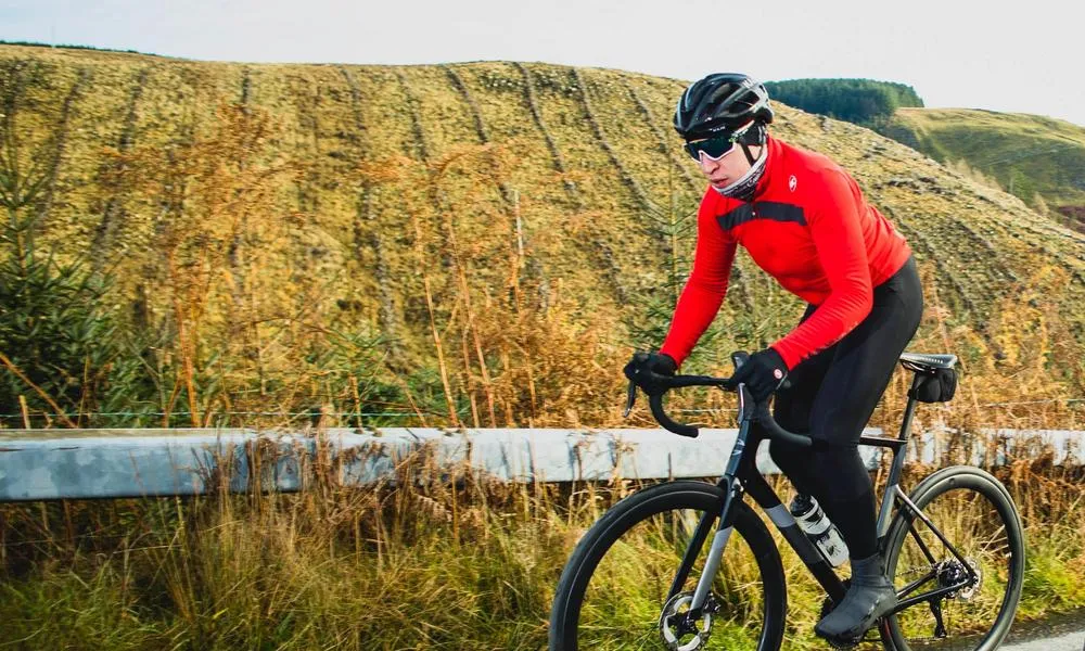 Road rider cycling up hill