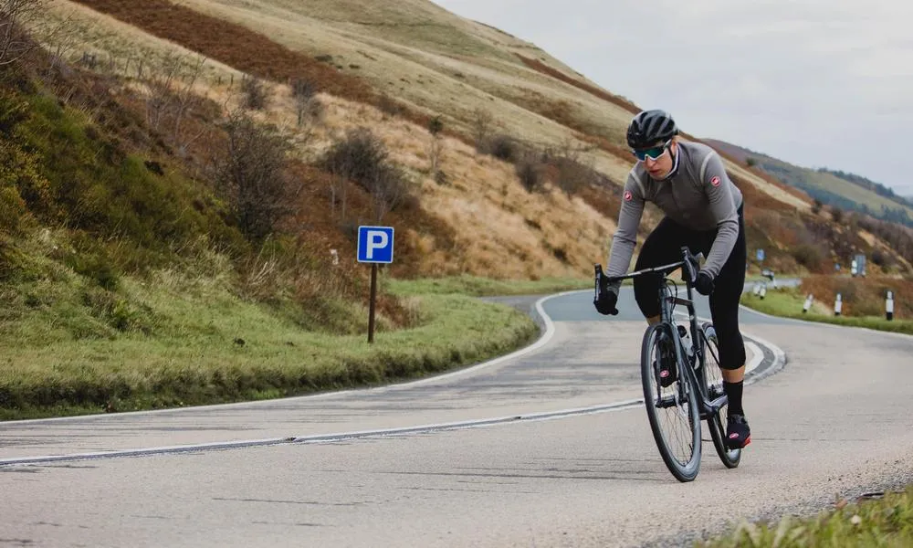 Road rider climbing wearing castelli