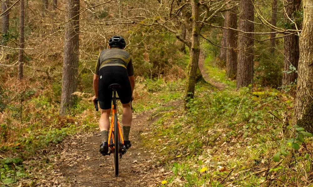 Gravel rider on singletrack in the woods