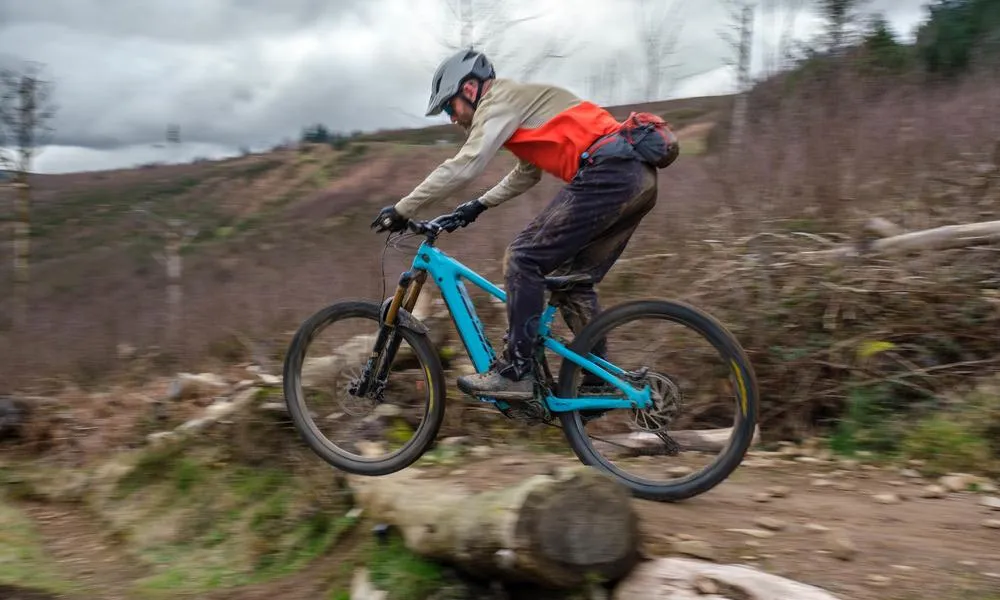 yeti ebike on descent over log 