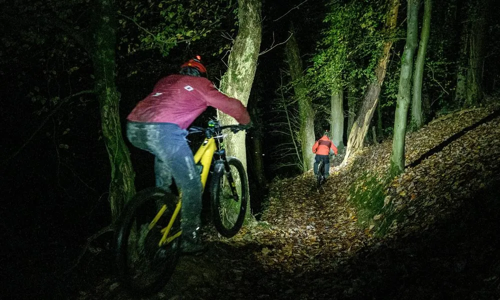 MTB night riders in dark with lights