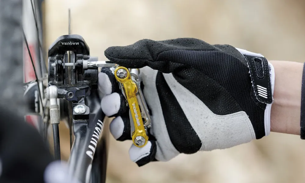 A Topeak Mini trail too is used to tighten a brake bolt