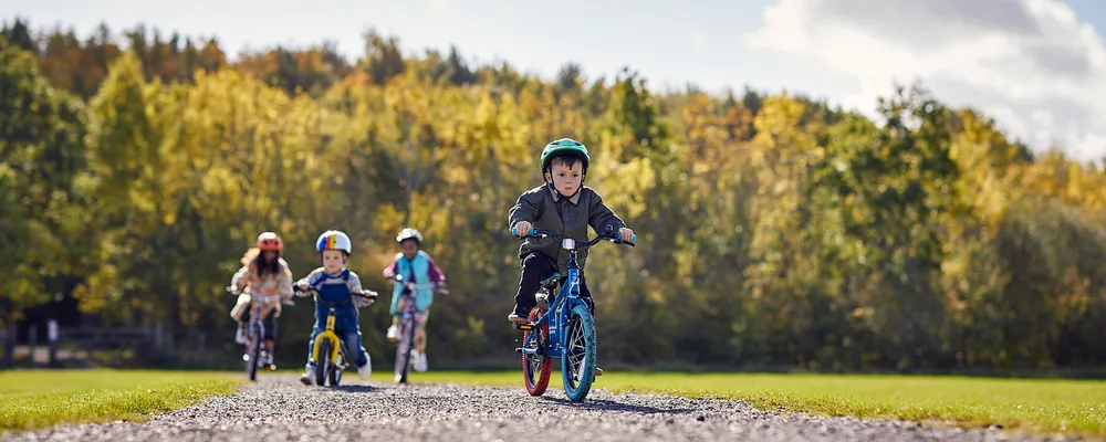 kids riding bikes on an autumn day, lead kid on 12" wheel bike